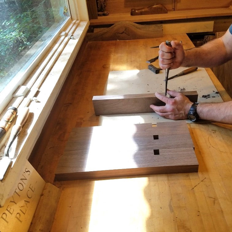 the furniture maker at Mokuzai Furniture cutting joinery for the legs of a coffee table.