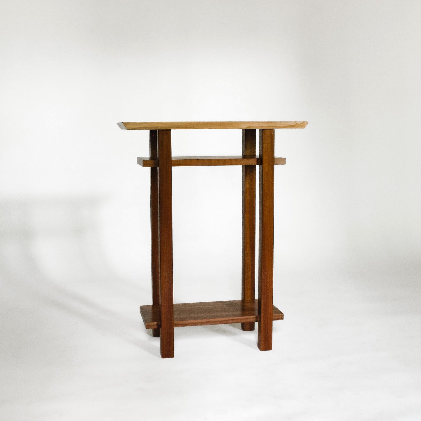 A small narrow minimalist end table with shelves from Mokuzai Furniture.