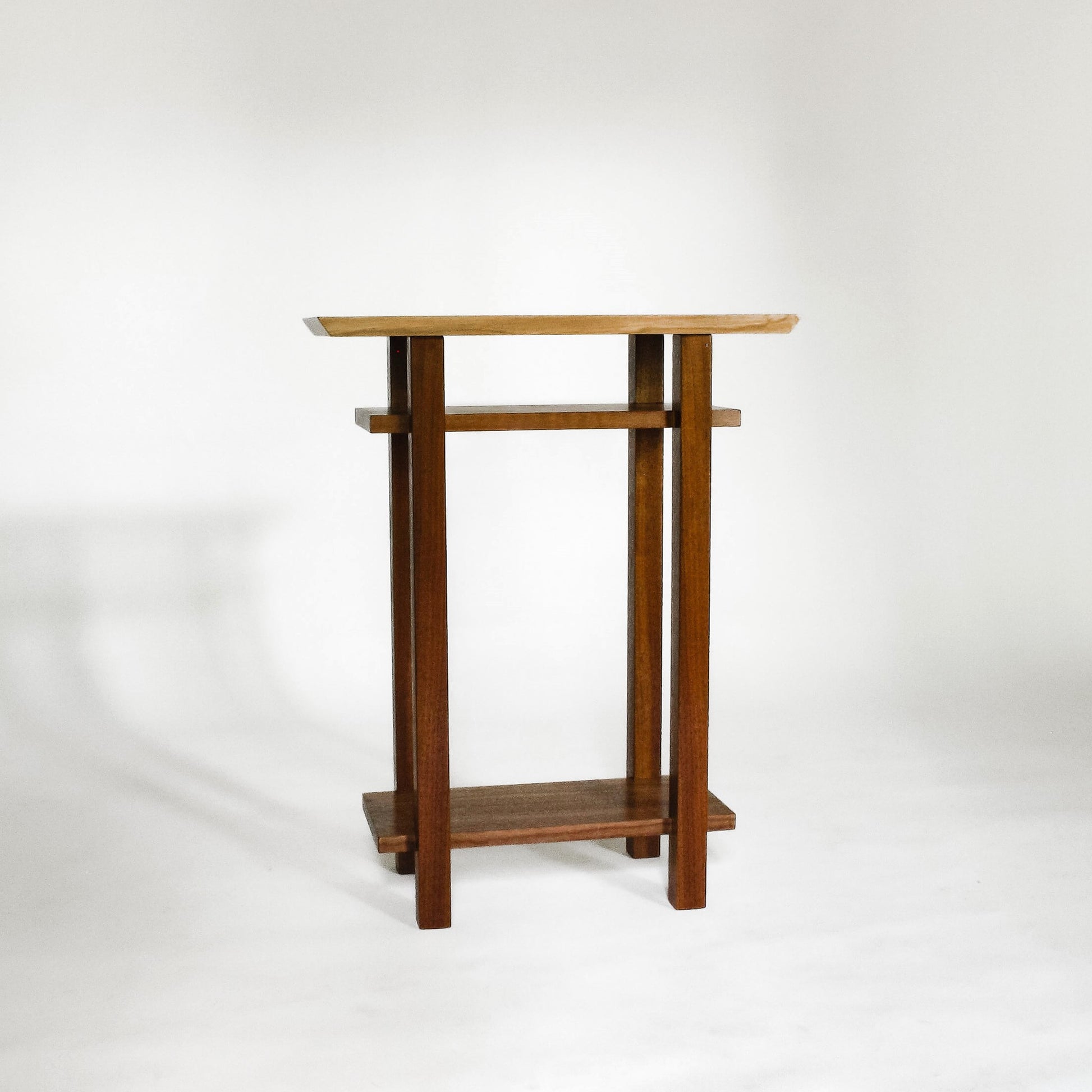 A small narrow minimalist end table with shelves from Mokuzai Furniture.