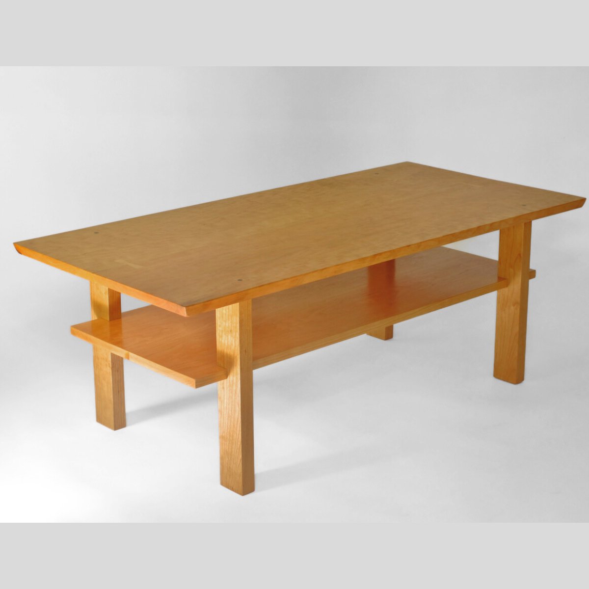A modern cherry coffee table for contemporary living rooms by Mokuzai Furniture.