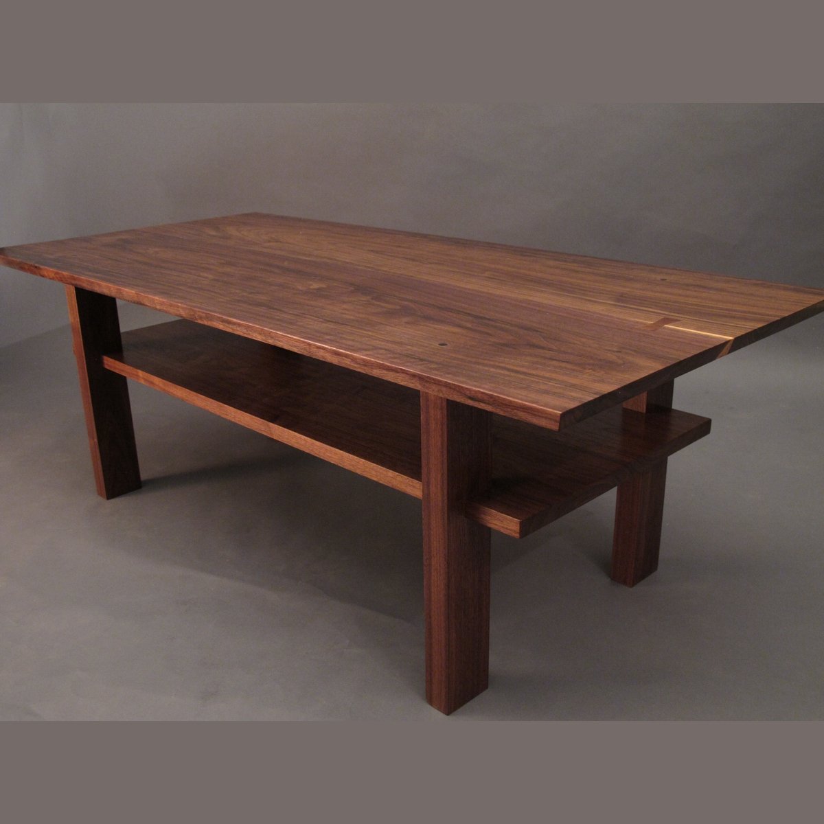 A modern coffee table design in solid walnut by Mokuzai Furniture.