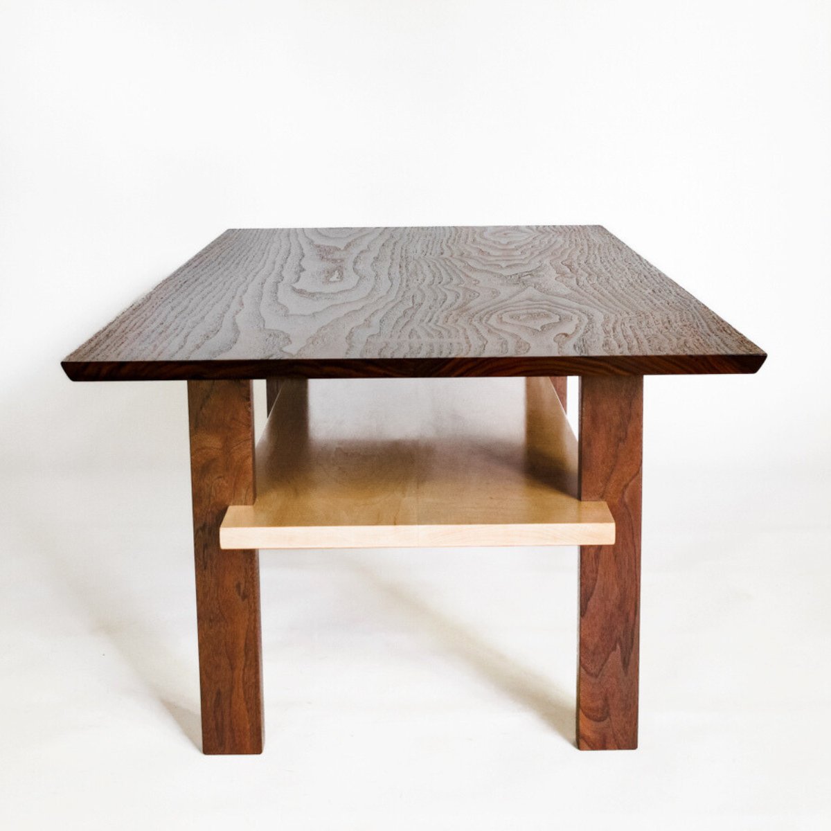 A narrow coffee table for modern living rooms by Mokuzai Furniture.