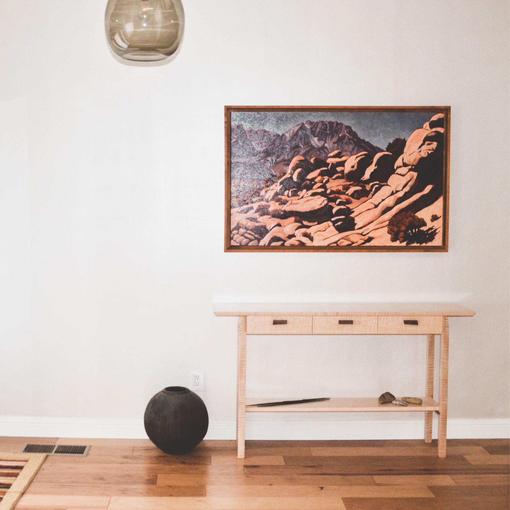 An elegant entry console table with narrow drawers and a shelf.  This modern wood console table is hand-crafted from unique tiger maple wood with walnut accents.  This narrow console table is perfect for entryways and hallway decor.