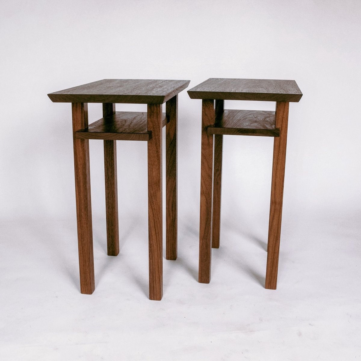 A set of thin end tables crafted from solid walnut from Mokuzai Furniture.