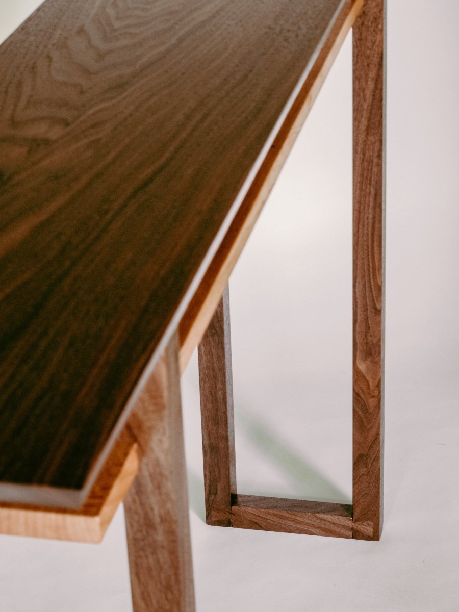 Uniquely designed dovetail feet add stability to the narrow table and offer beautiful visual details