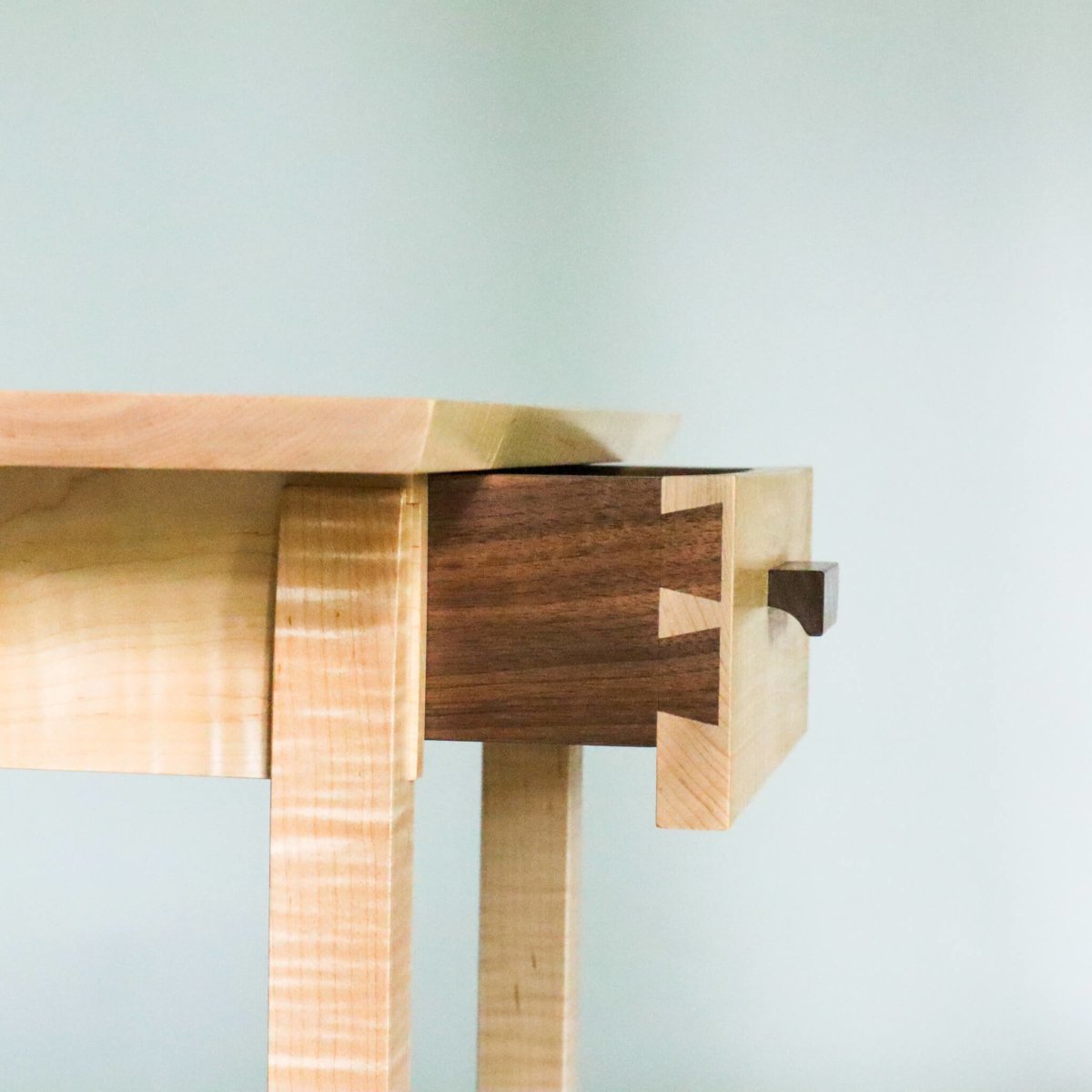 solid wood end table with drawer, tiger maple with walnut, dovetail details at the side of the drawers in these nightstands with drawer storage by Mokuzai Furniture