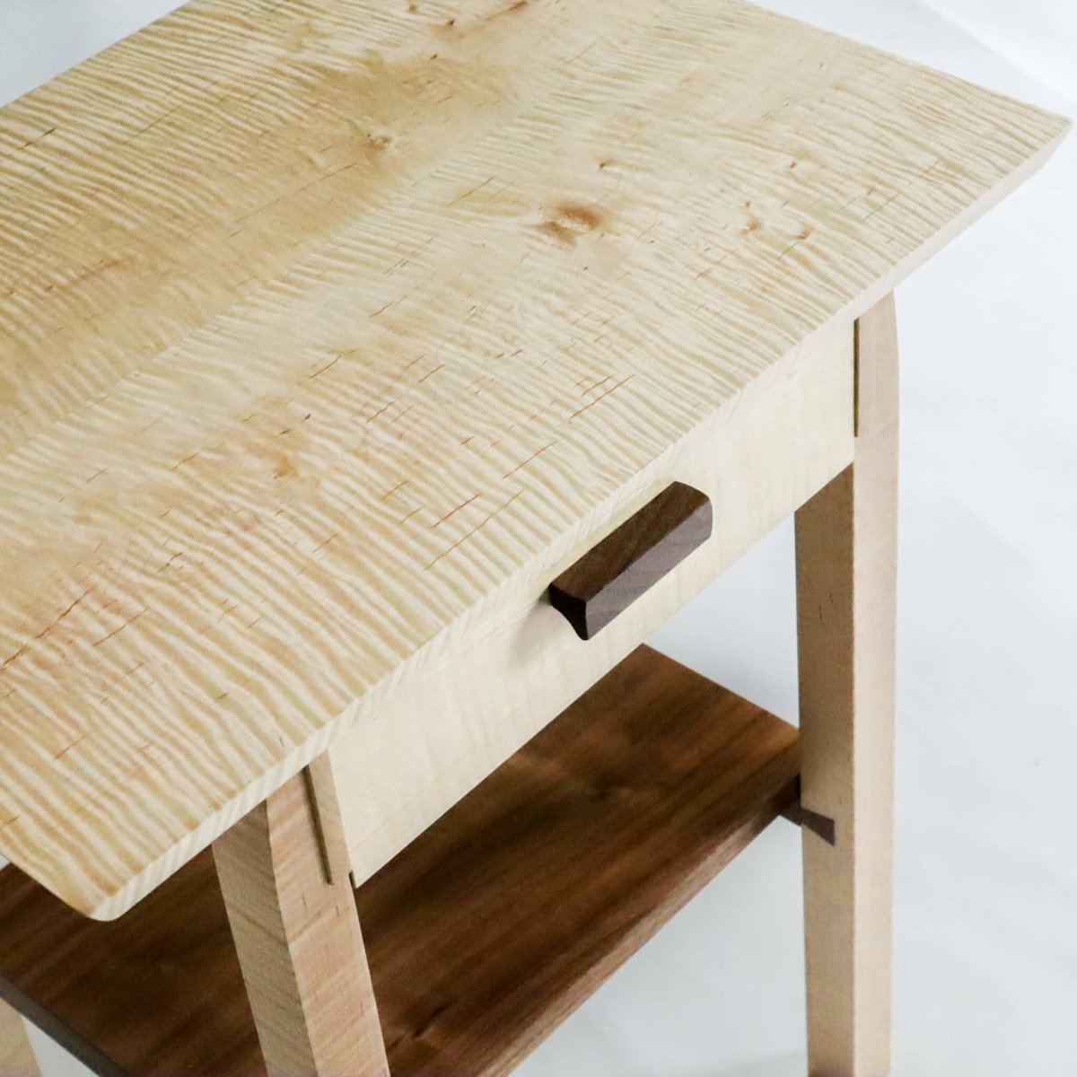 Stunning tiger maple wood shimmers with light and deep walnut wood tones contrast beautifully on this unique bed side table by Mokuzai Furniture - contemporary nightstand with storage