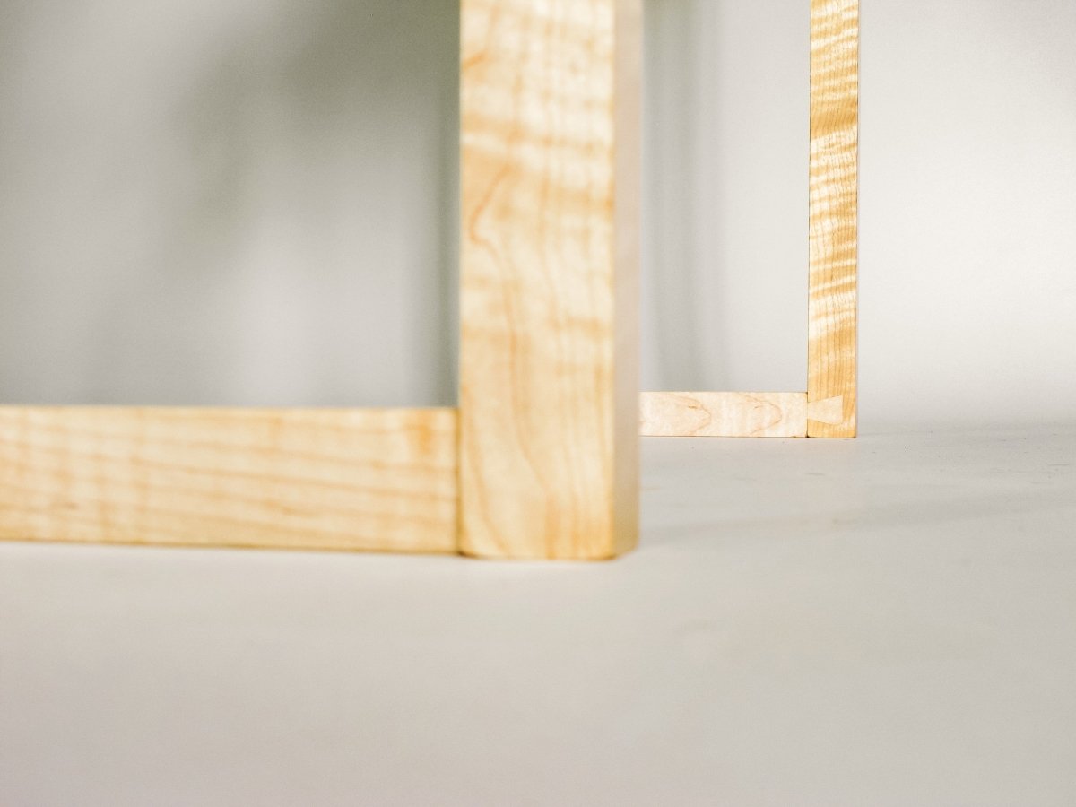 hand-cut dovetail detail at the feet of this mid-century modern style console table with wine storage - dining room decor by Mokuzai Furniture