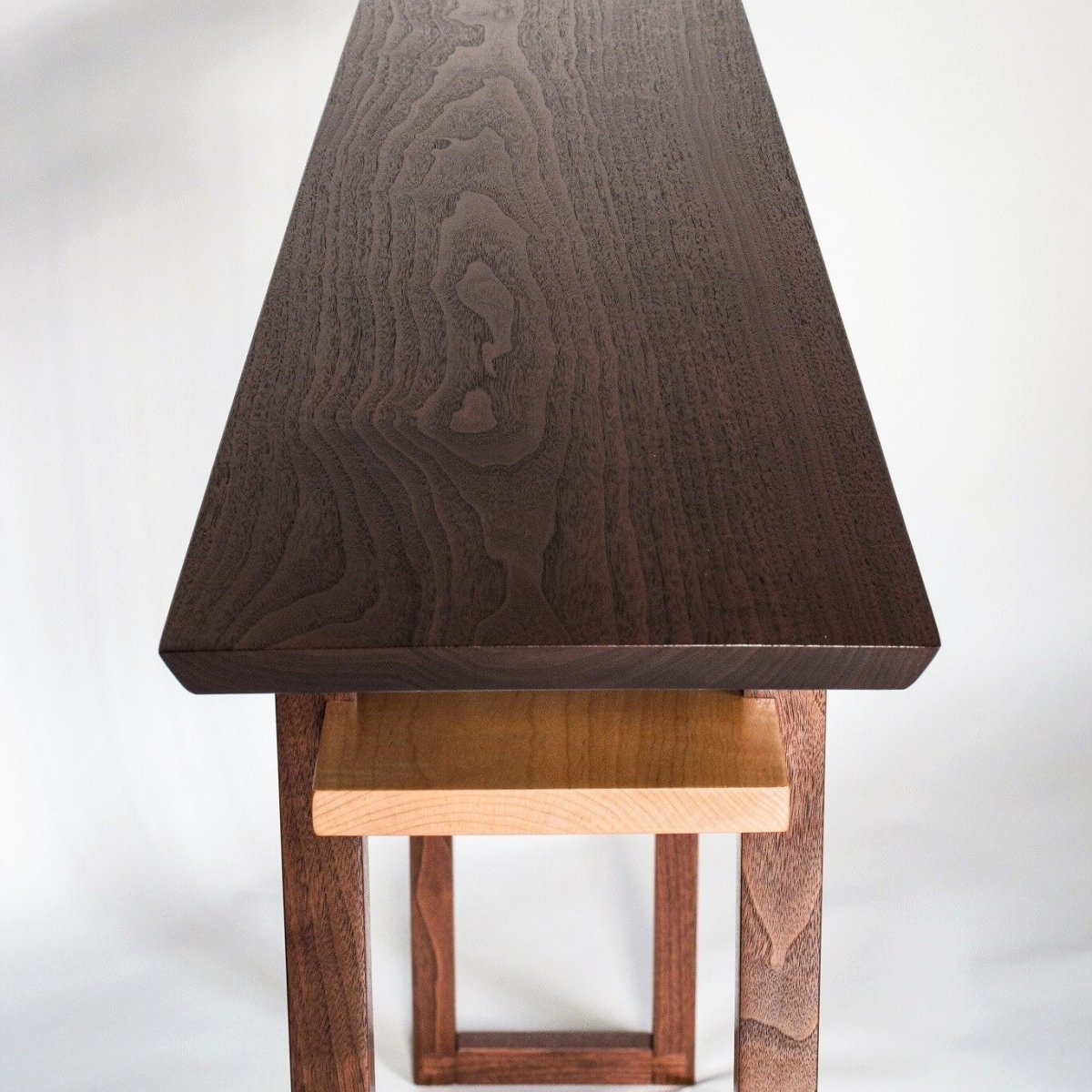 This thin console table made from walnut, has a shelf made from tiger maple. The thin console table design is perfect for your entry console table, or hall console table. Modern wood furniture designs from Mokuzai Furniture