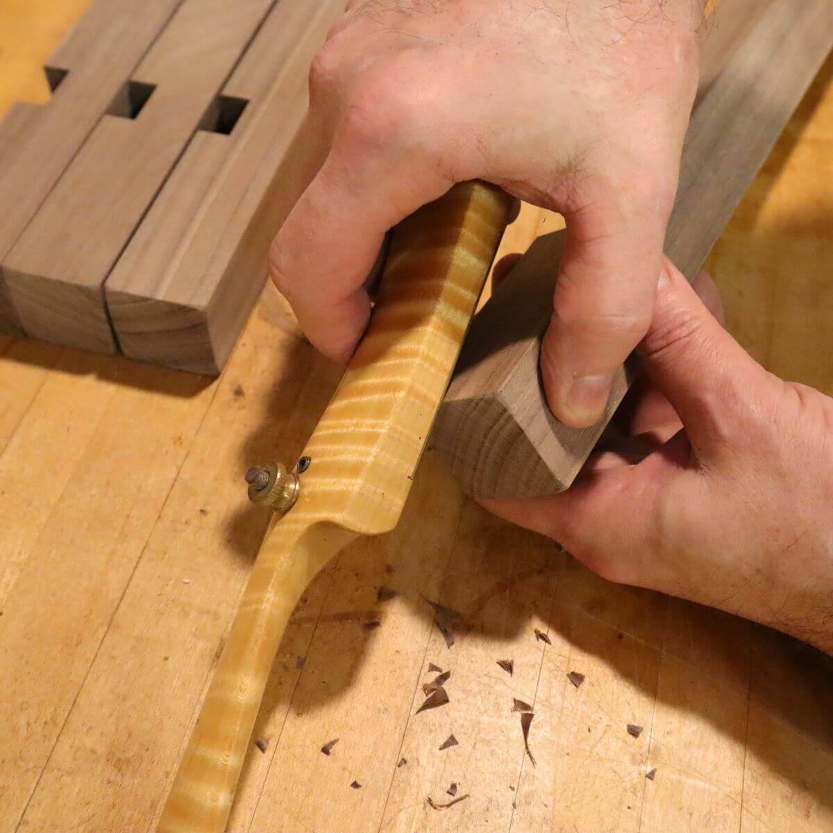 a fine furniture maker shapes the ends of console table legs