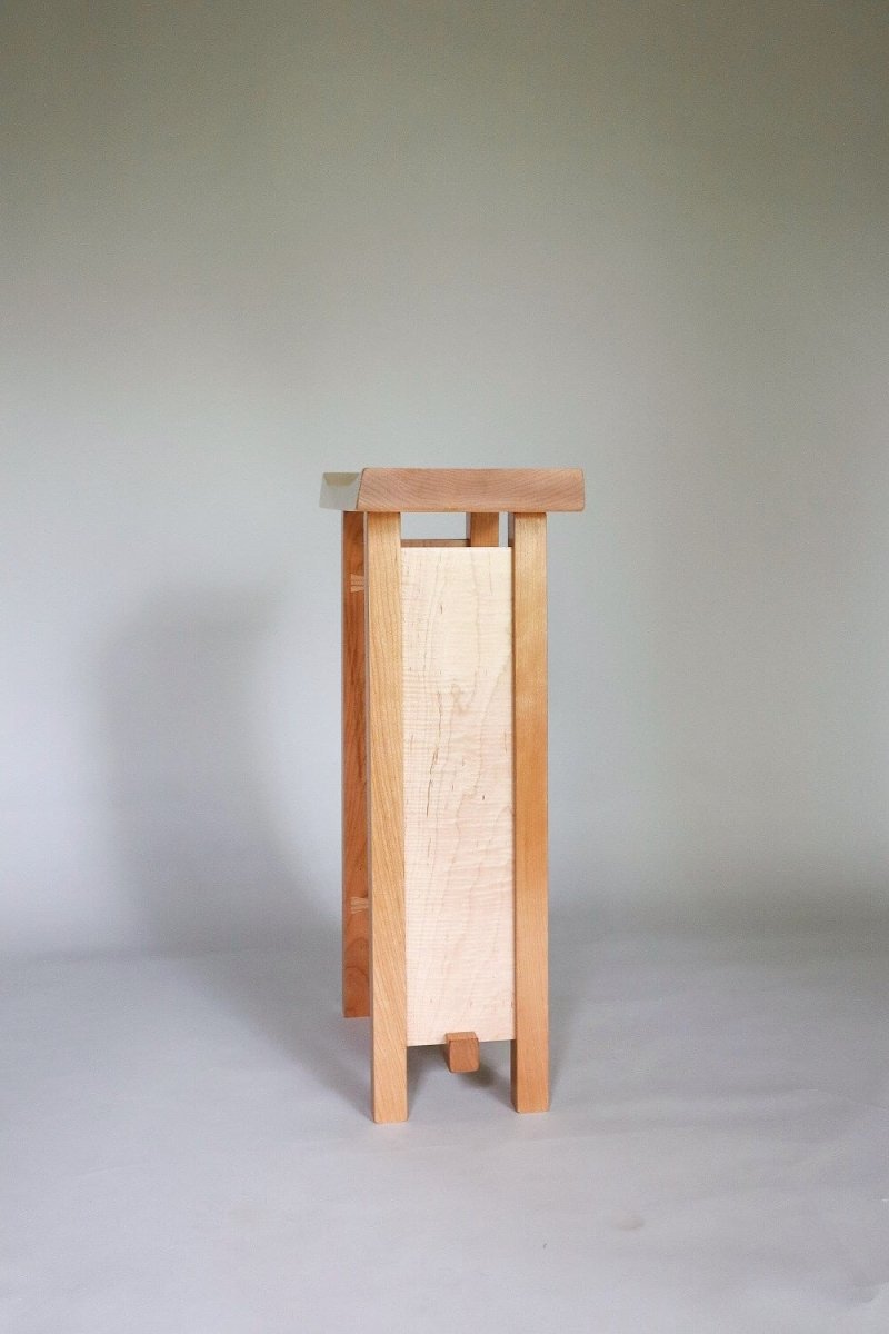 A narrow nightstand with elegant handcrafted details by Mokuzai Furniture.