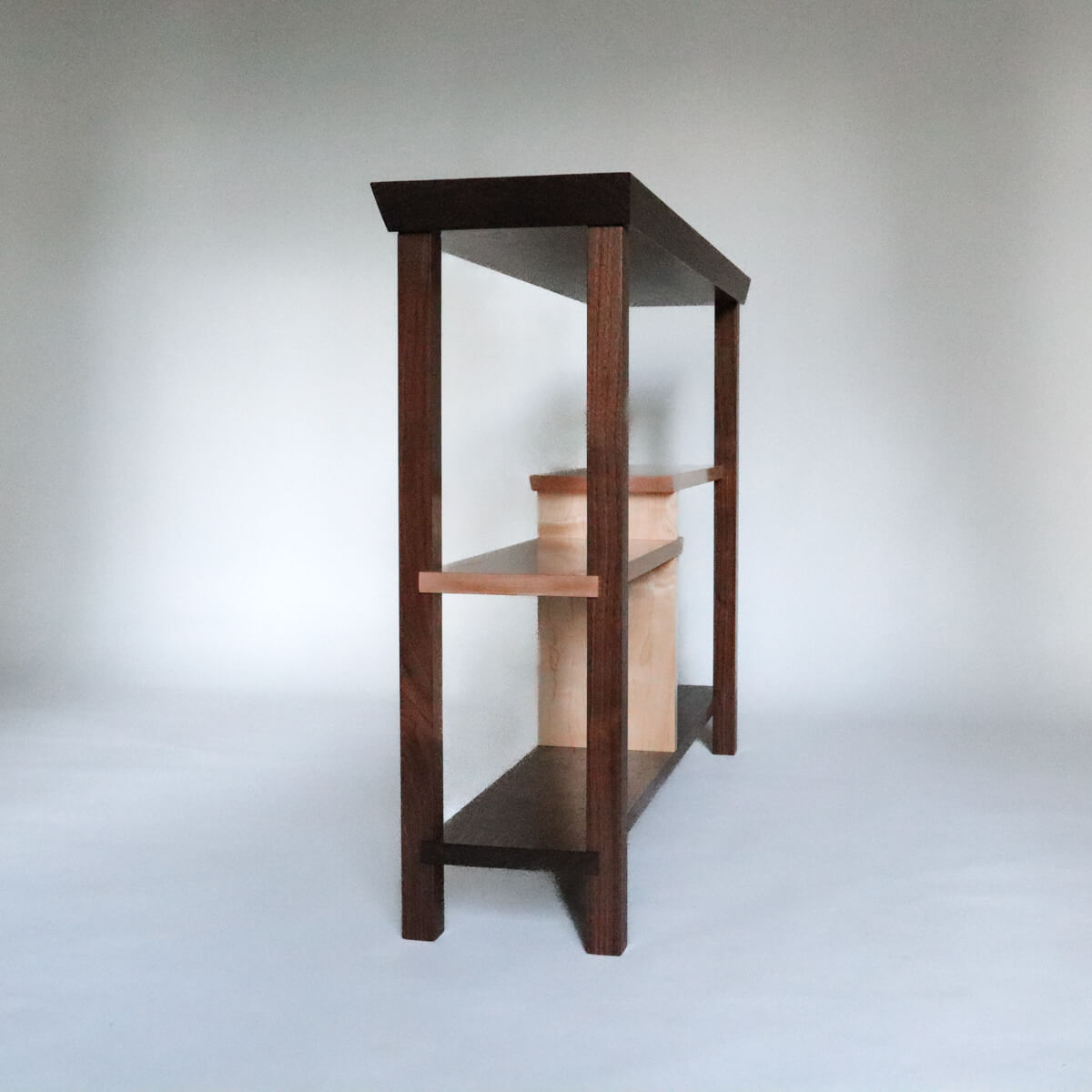 A Japanese style console table with shelves for books by Mokuzai Furniture
