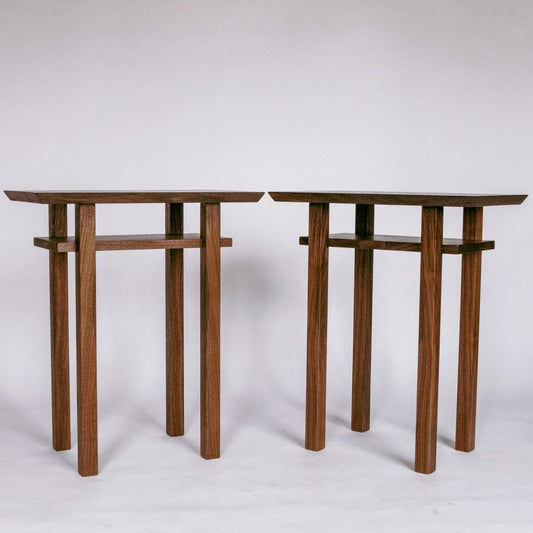 A pair of small end tables handmade from solid walnut by Mokuzai Furniture.