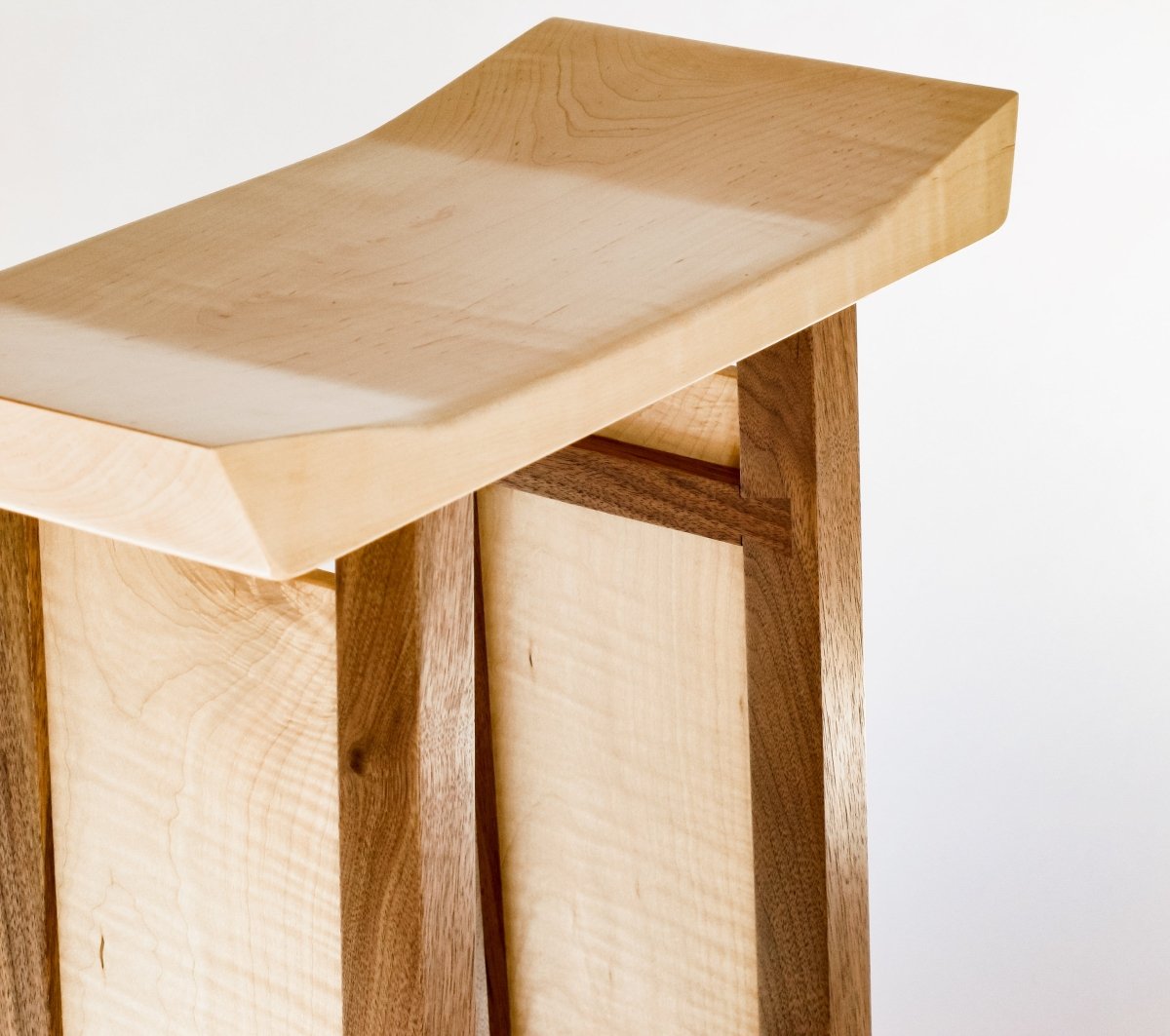 An artistic bedroom furniture design, this is our Shaped Bedside Table in tiger maple and walnut by Mokuzai Furniture.