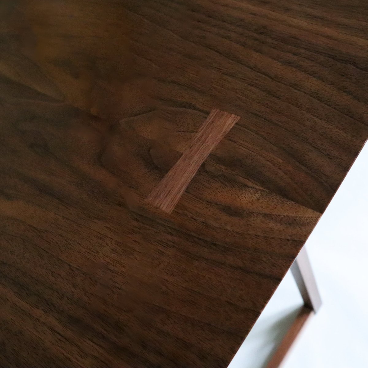 Butterfly key inlay detail on a living room console table from Mokuzai Furniture.