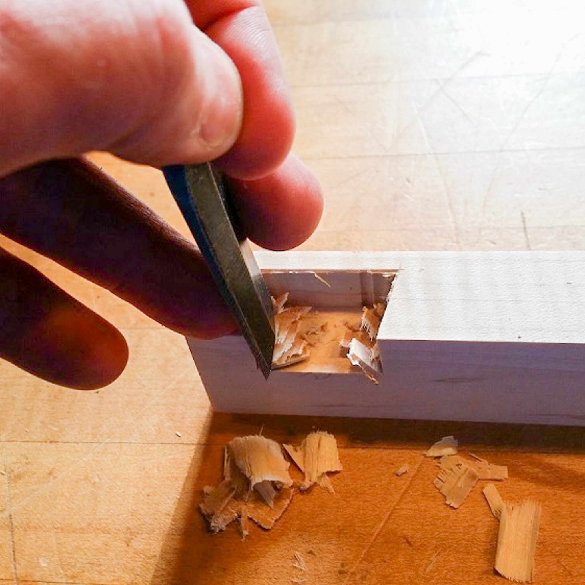 cutting dovetails for a modern media console cabinet.