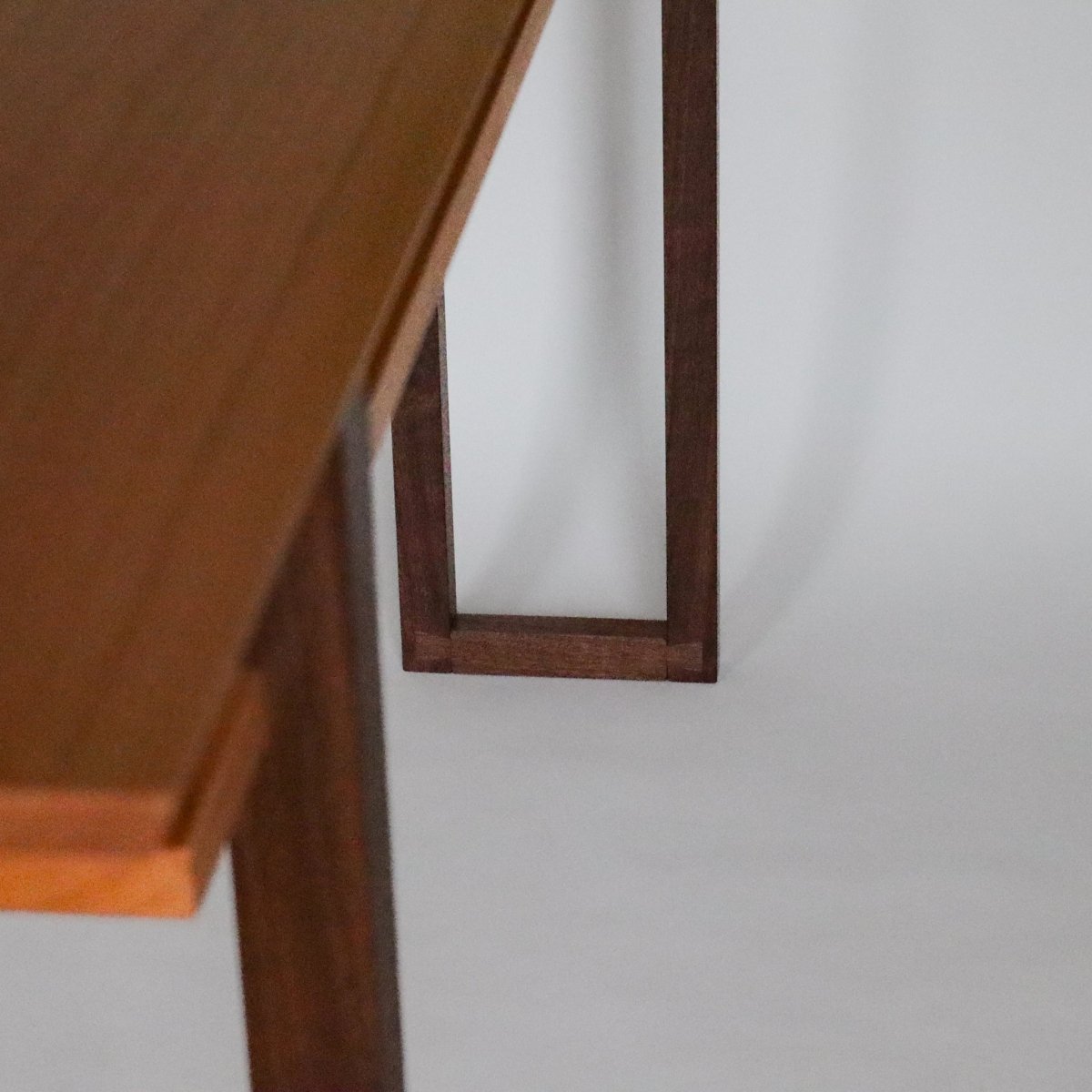 Dovetail details showing elevated craftsmanship on a long narrow console table by Mokuzai Furniture.