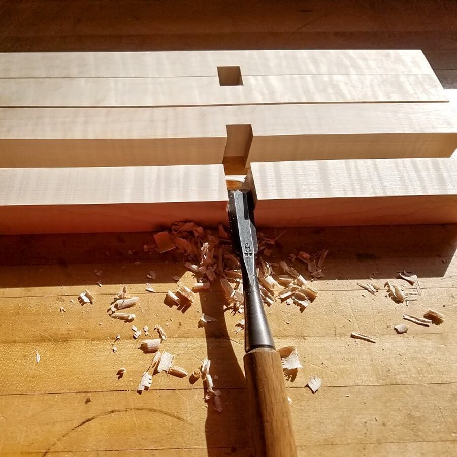 furniture maker cuts joinery for shelf of modern wood bench at Mokuzai Furniture