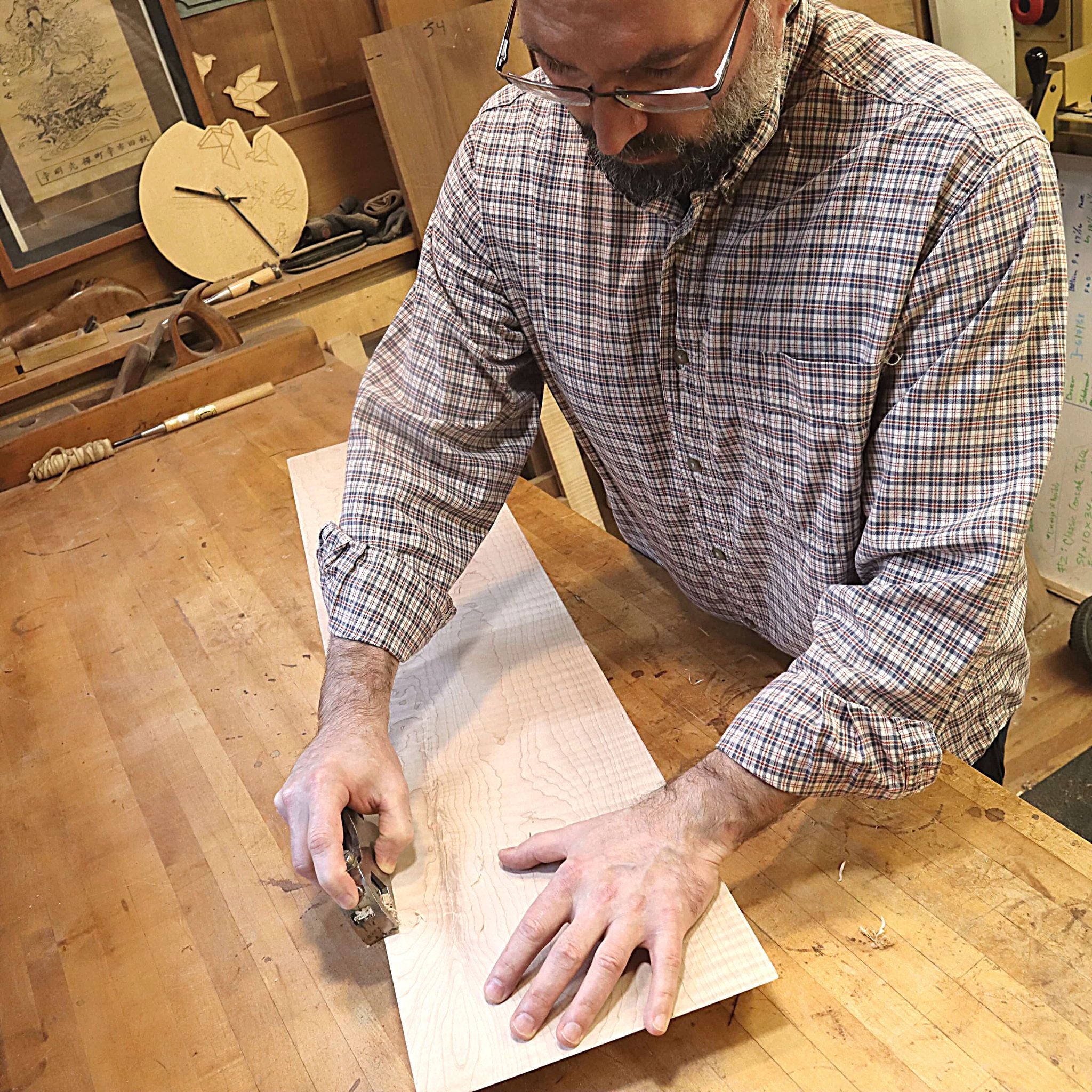 At Mokuzai Furniture, the furnituremaker hand planes the details of a custom console table.