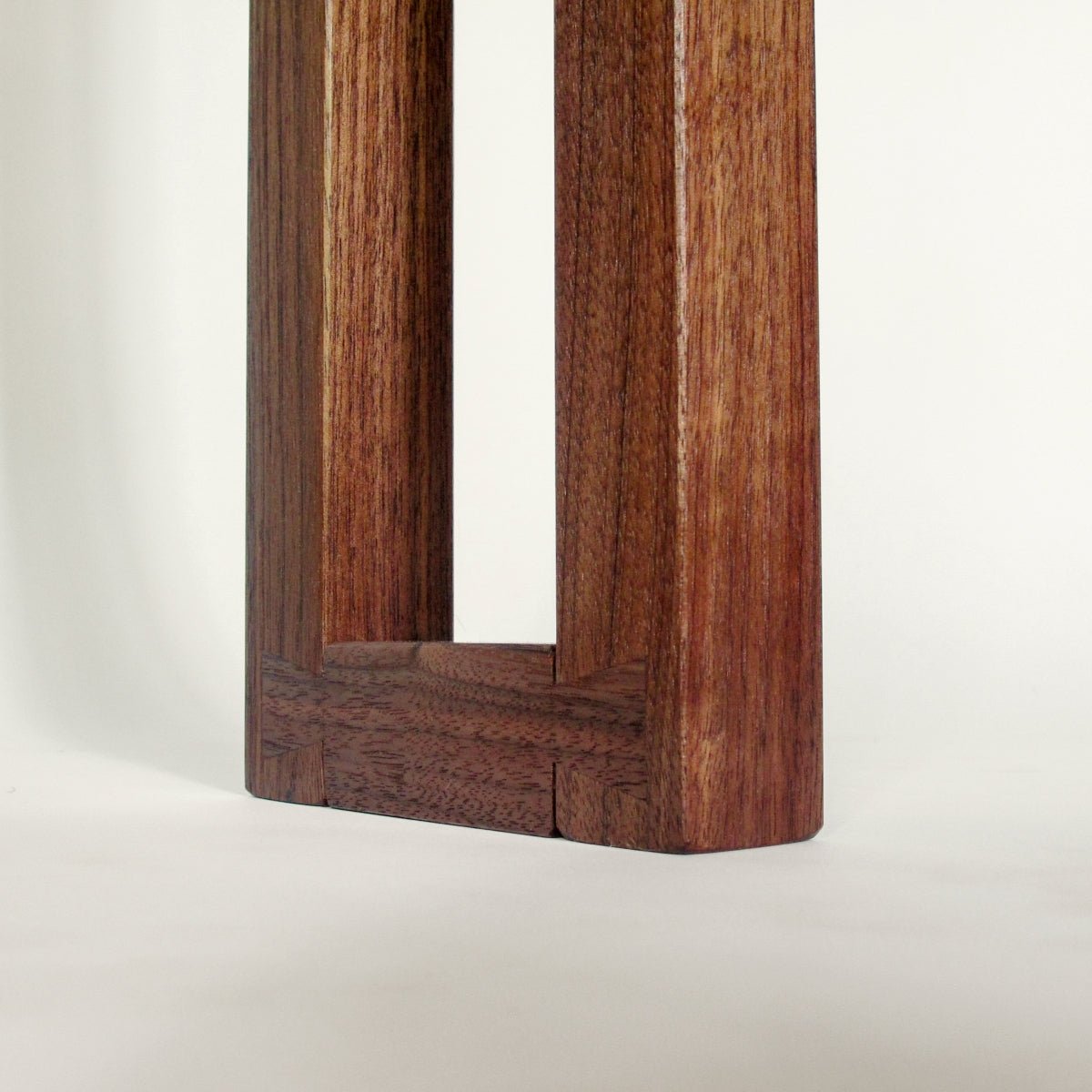 Hand-cut dovetail details on the fee of a 7 inch wide side table for entryways from Mokuzai Furniture.