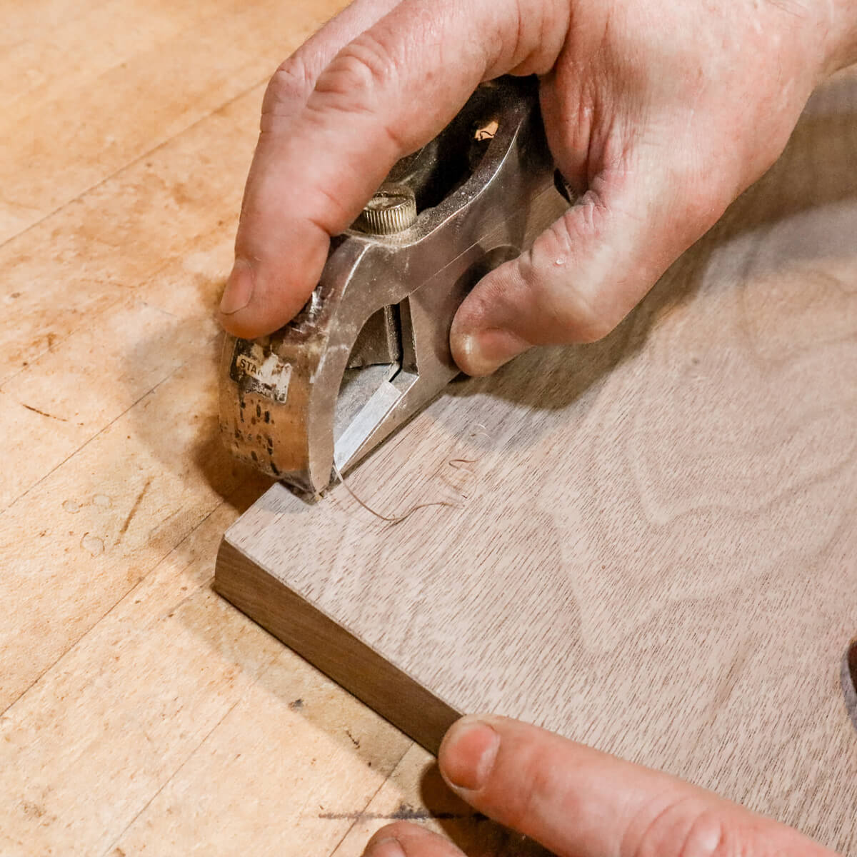 custom furniture maker hand planes shelf of a modern wood bench at Mokuzai Furniture