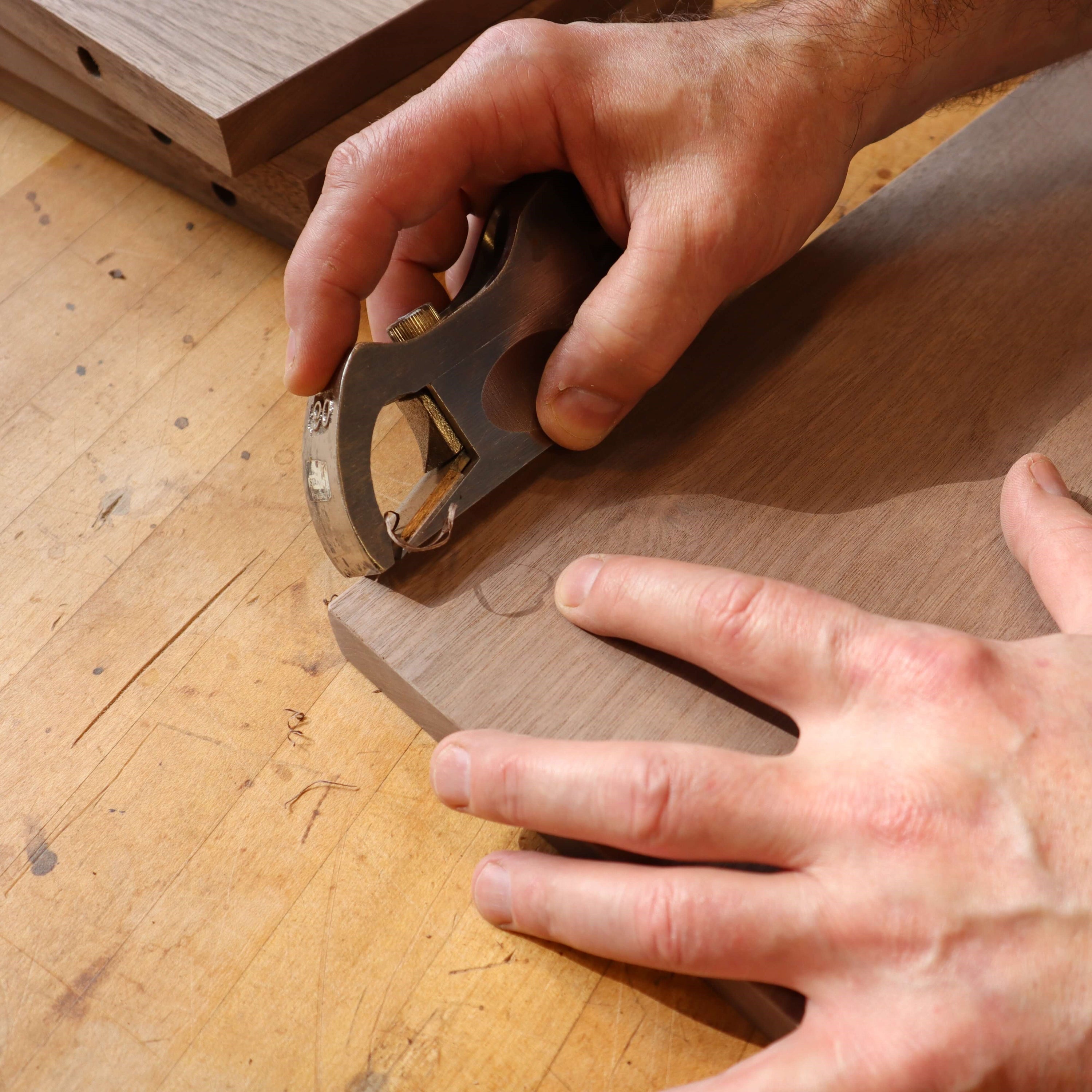 handplaning the shelf of a custom end table by Mokuzai Furniture