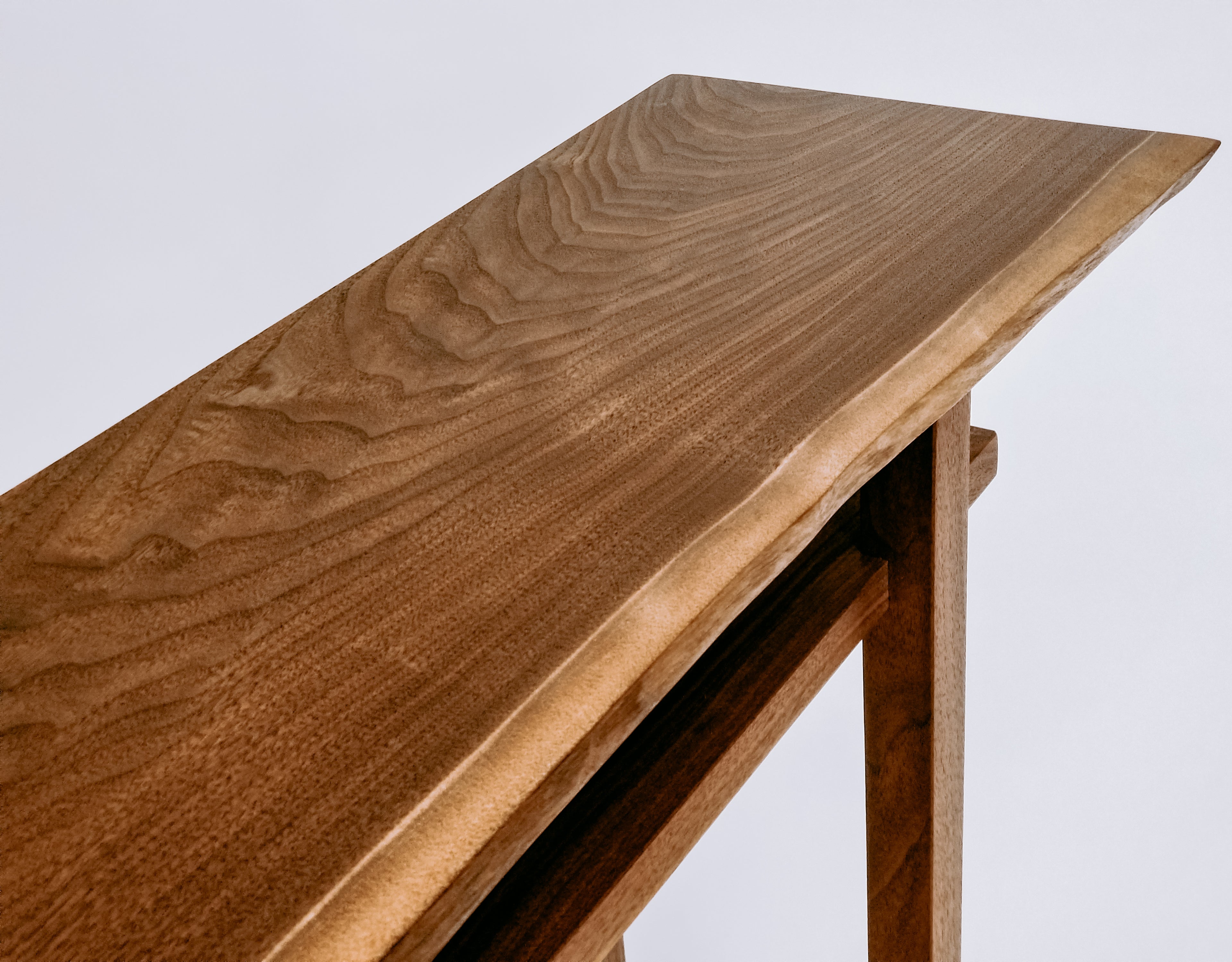 A live edge walnut hall table from Mokuzai Furniture.  Our modern console table designs are narrow for hallways and entryways.