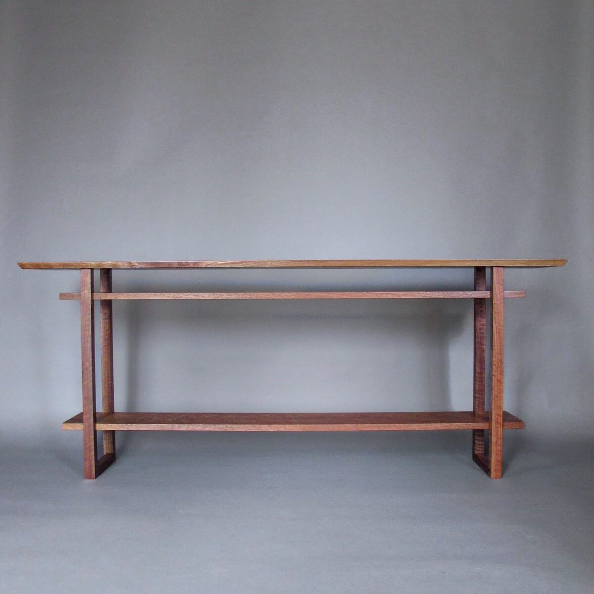 A long console table with two shelves for hallways and entryways by Mokuzai Furniture.