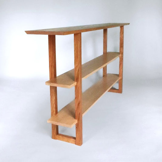 A modern narrow console table with two shelves for entryways and dining rooms from Mokuzai Furniture.