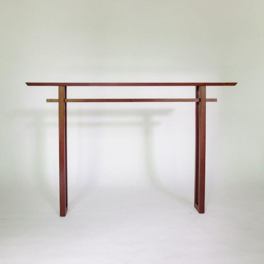 A narrow Japanese console table in solid walnut handmade by Mokuzai Furniture.