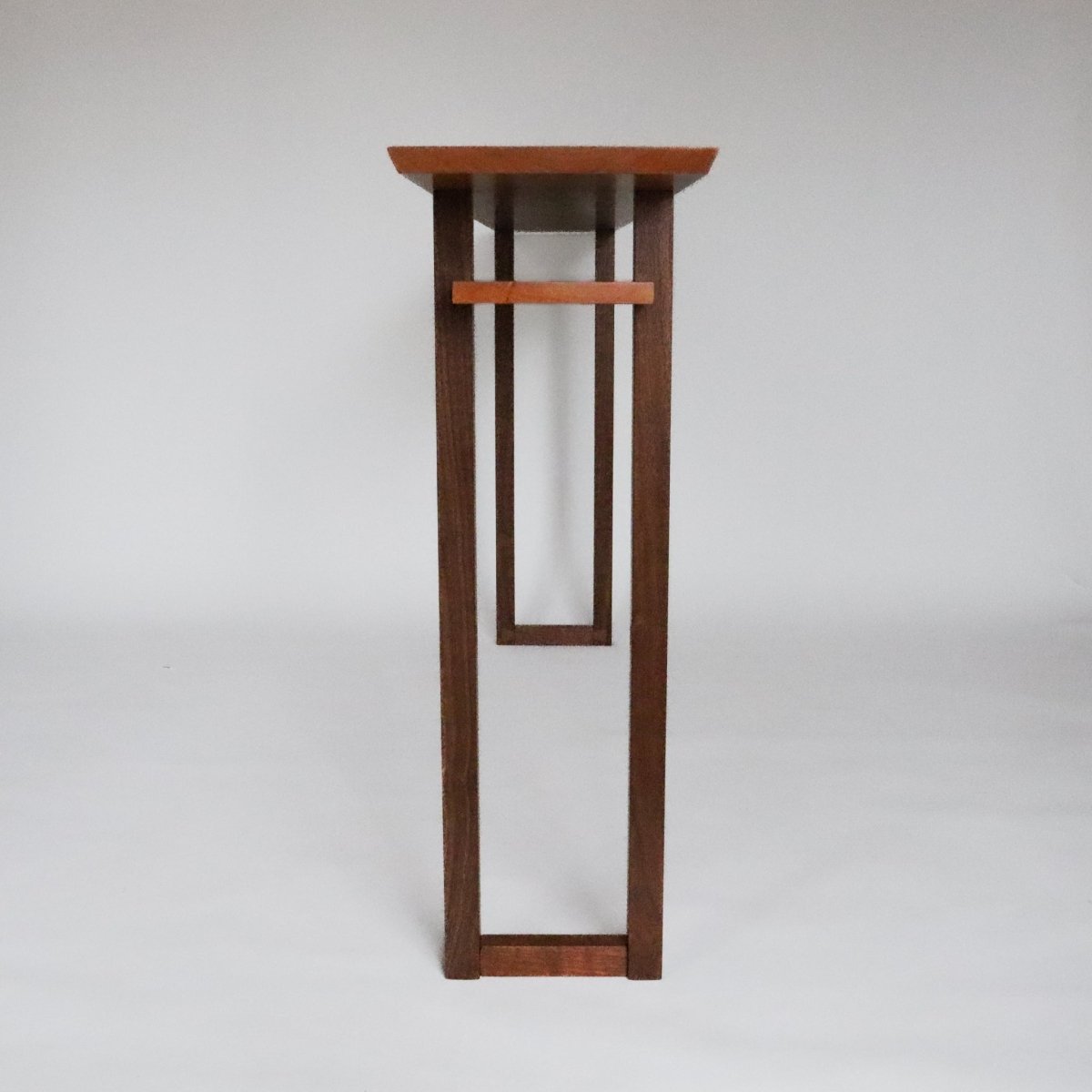 A long narrow console table with shelf from Mokuzai Furniture.