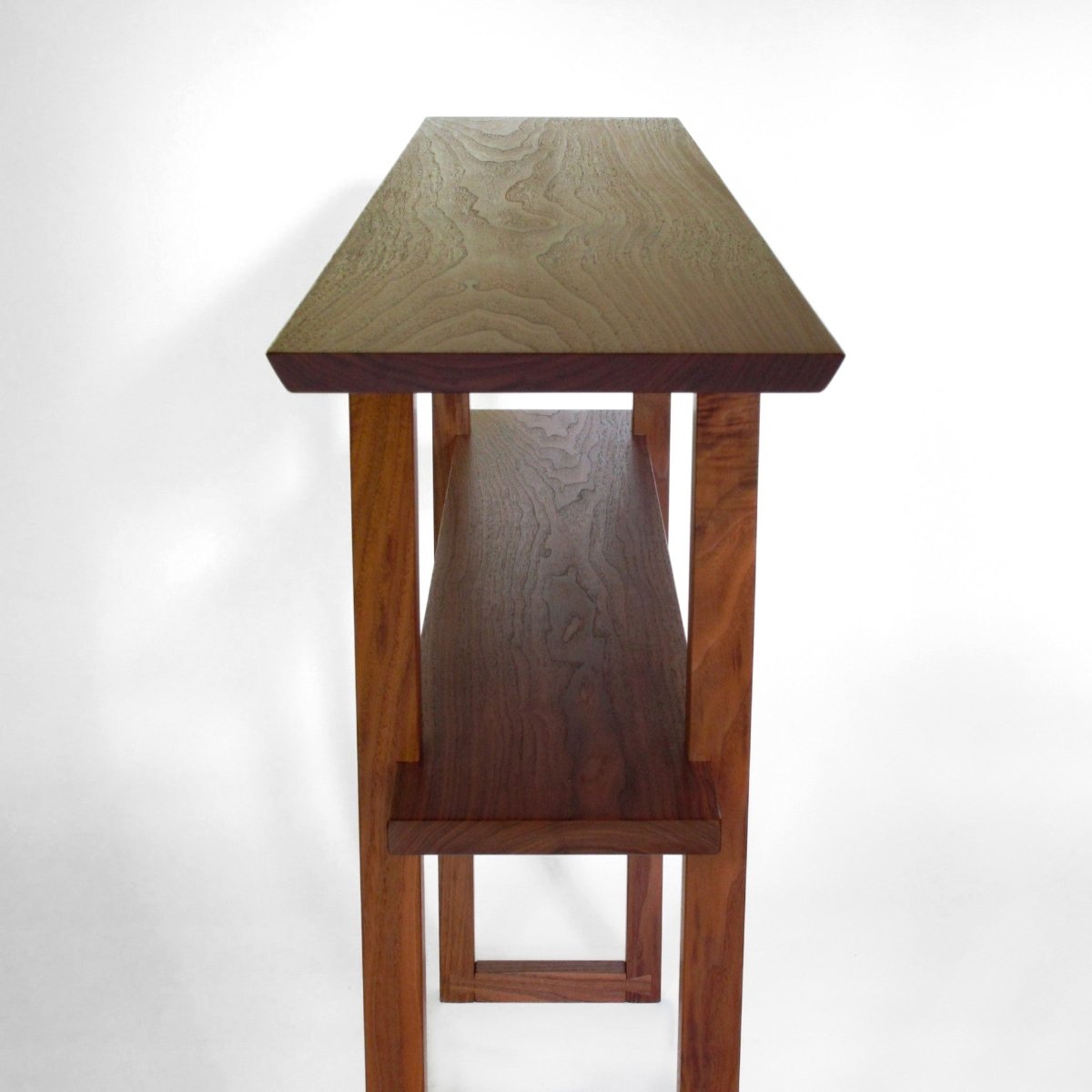 A narrow walnut sofa table for modern living rooms or entryways from Mokuzai Furniture.