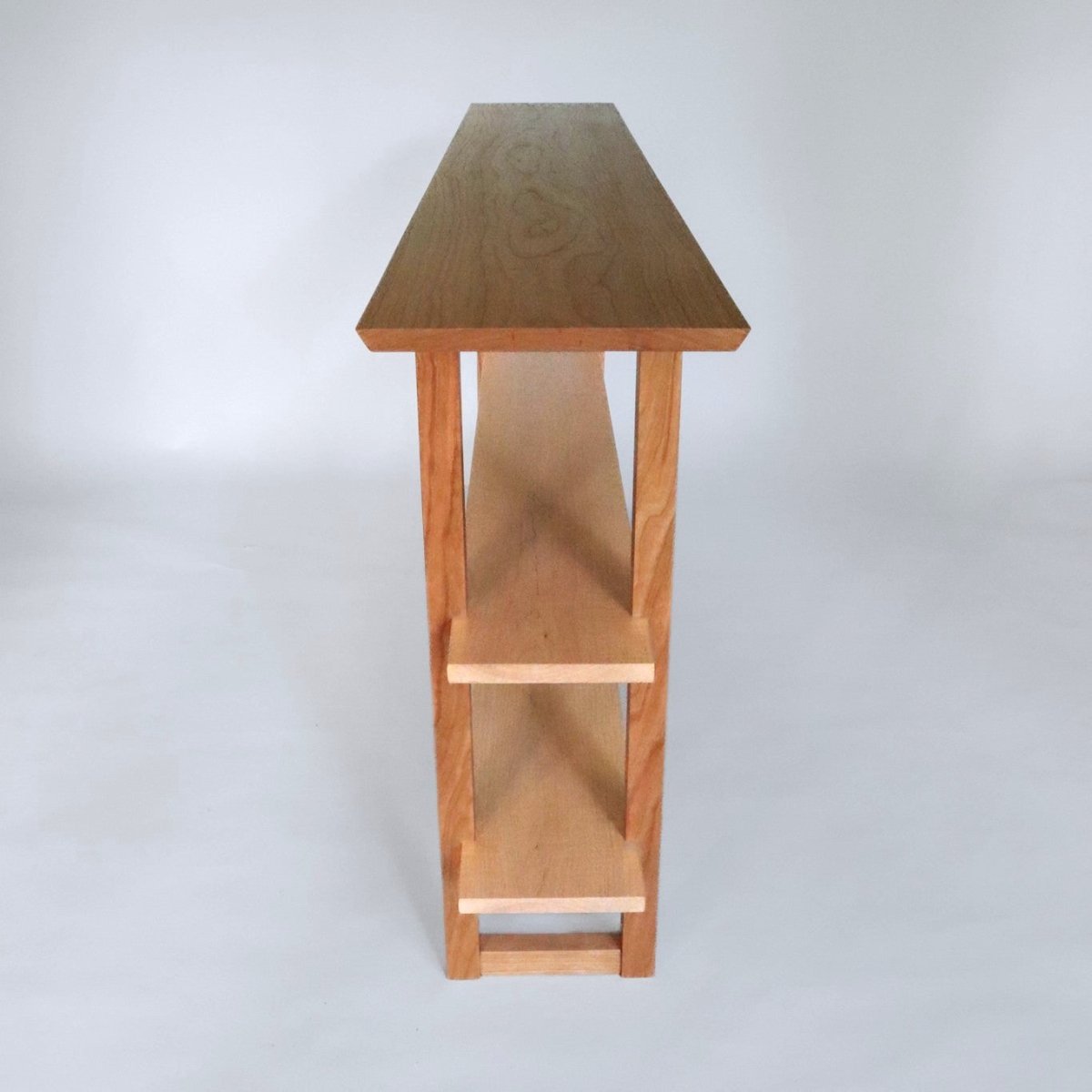 A skinny console table in cherry with tiger maple shelves for a dining room sideboard from Mokuzai Furniture.