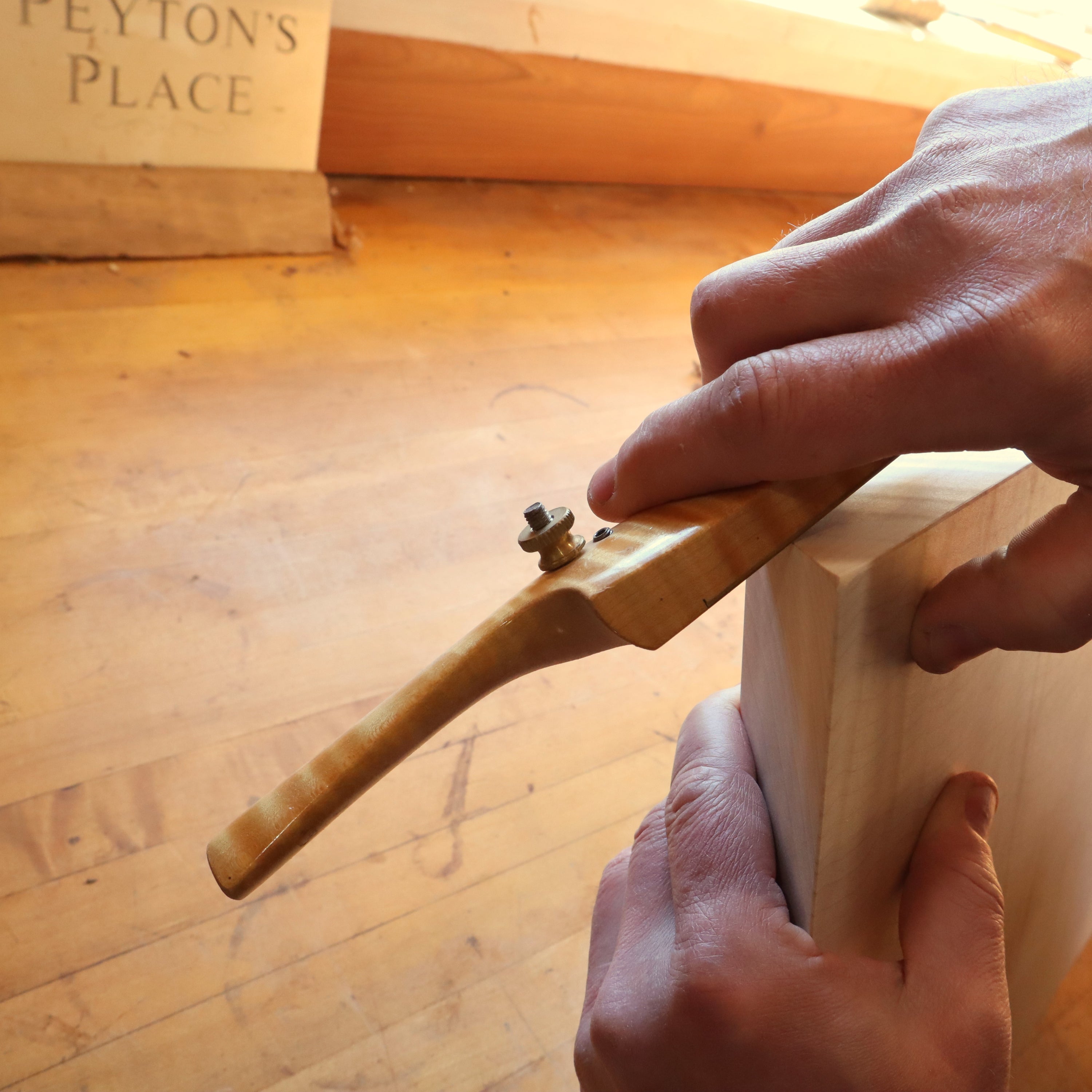 creating corner details with a spokeshave on a modern zen side table at Mokuzai Furniture