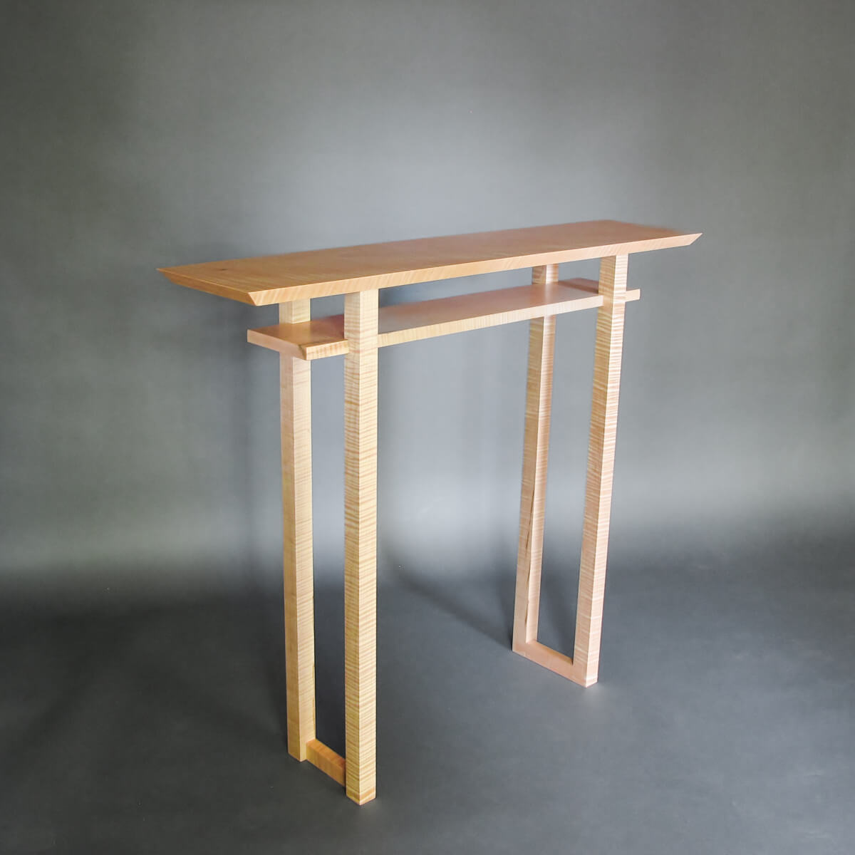 a unique hallway table handmade from tiger maple wood by Mokuzai Furniture