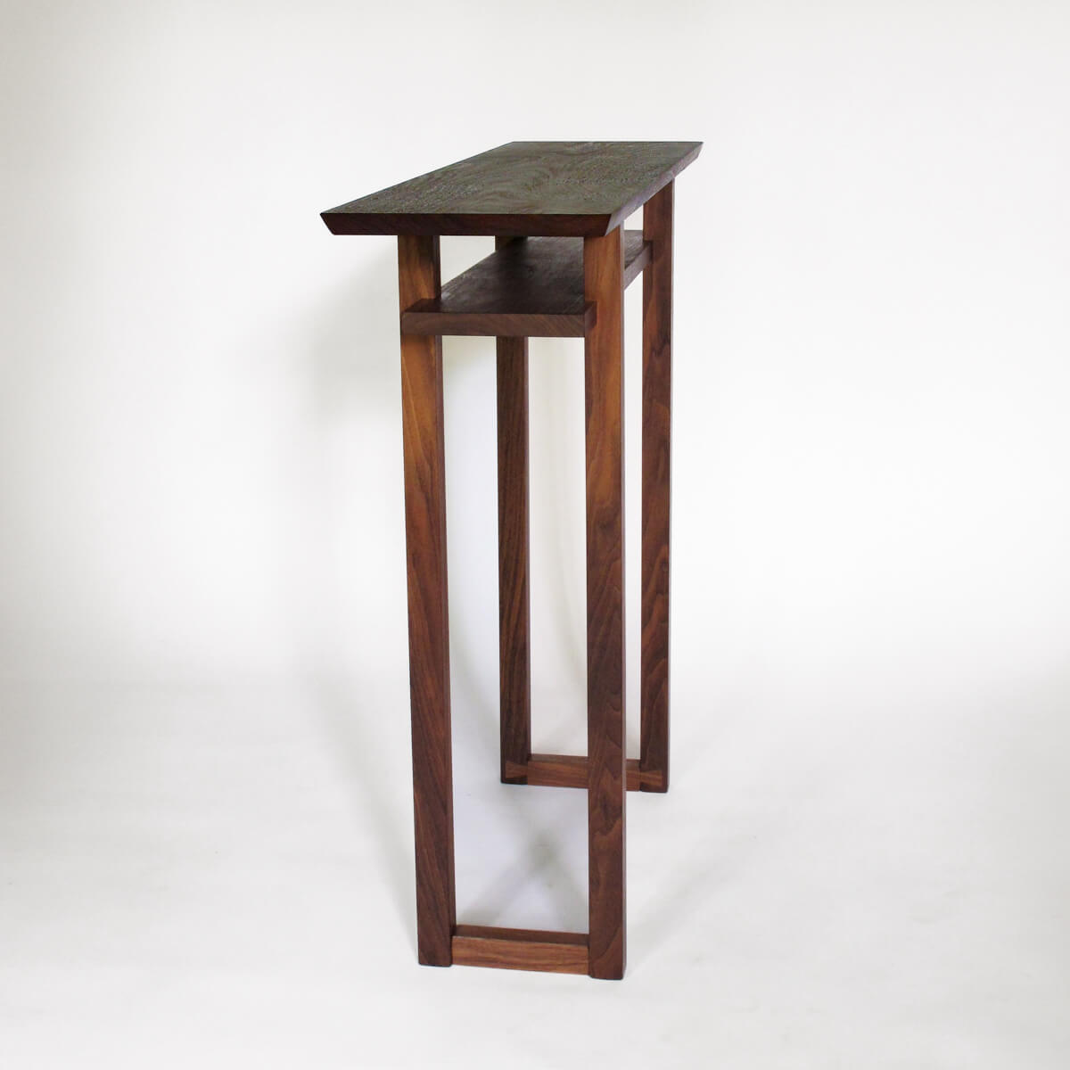 a narrow walnut side table for hallways by Mokuzai Furniture