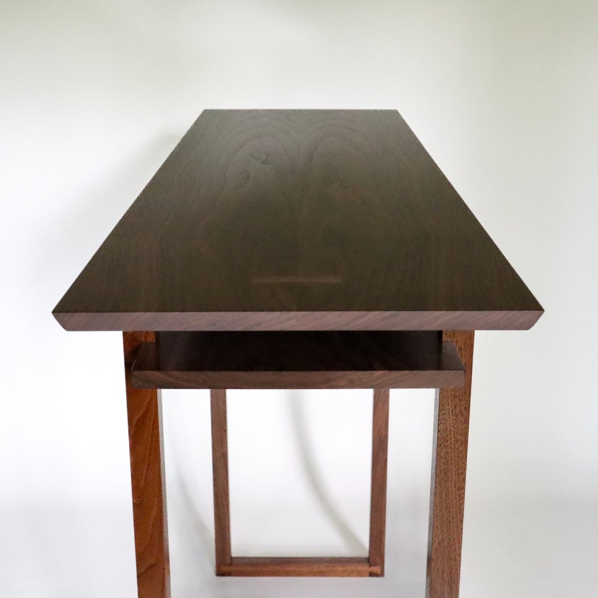 A walnut tv console table with butterfly key inlay details from Mokuzai Furniture.
