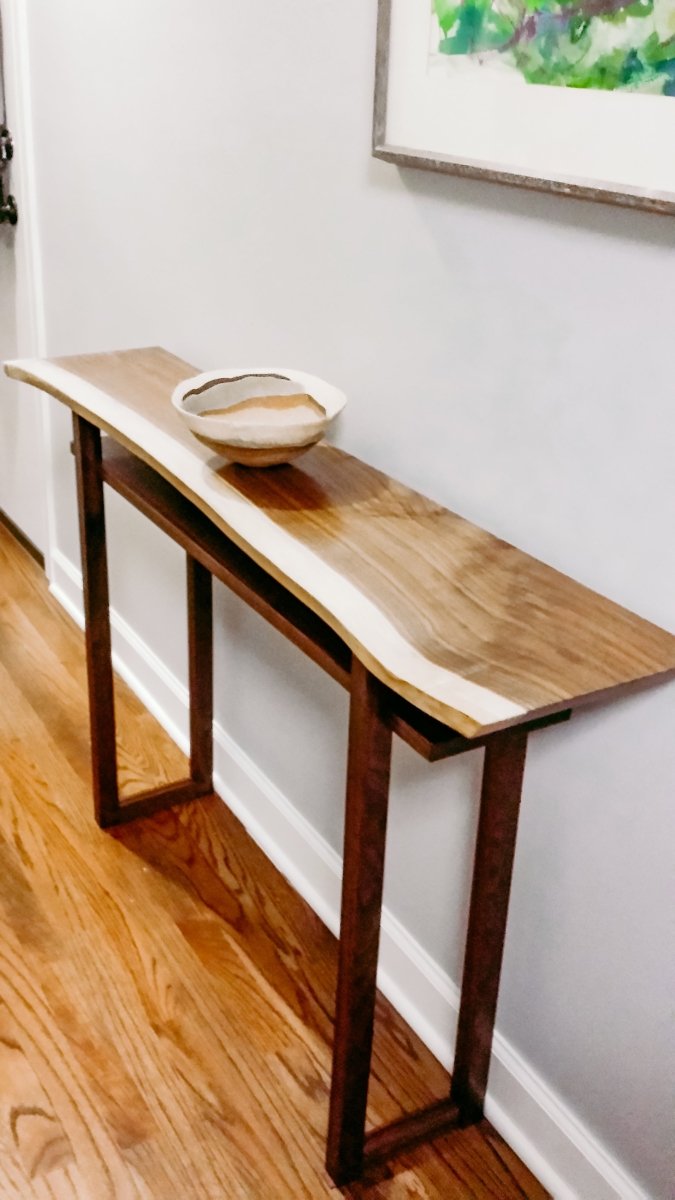 a live edge hall console table in solid walnut.  minimalist table for narrow hallway decorating.  A modern entryway furniture design for small spaces.