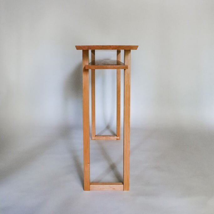 A cherry console table in a narrow table size making it a contemporary console table for entryways.  Premium wood furniture designed by Mokuzai Furniture