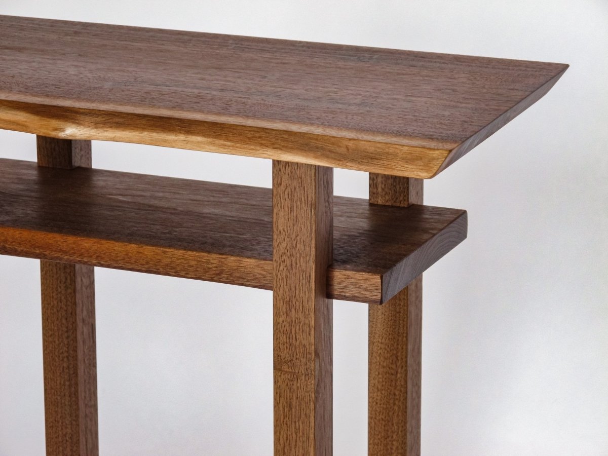 A narrow walnut table for an end table or small nightstand