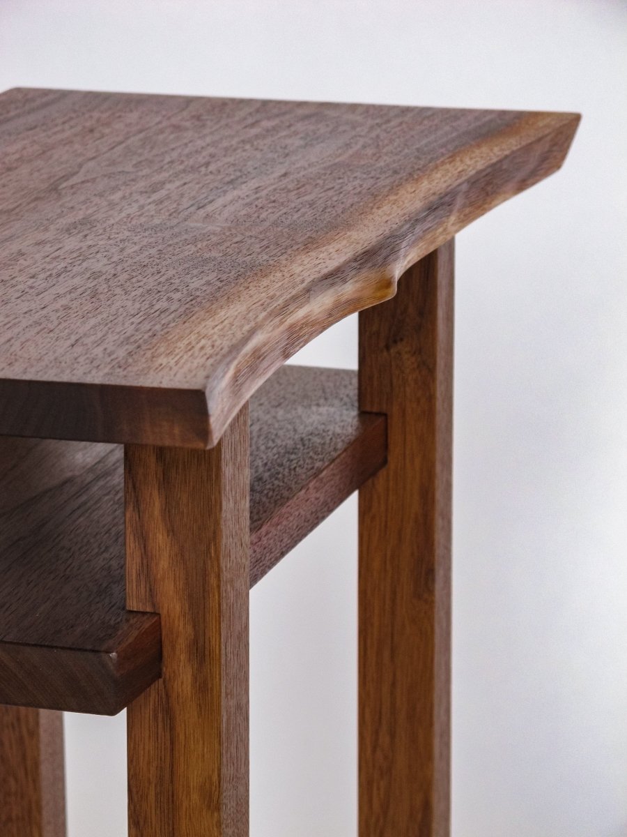 A natural edge on the front of this live edge walnut end table