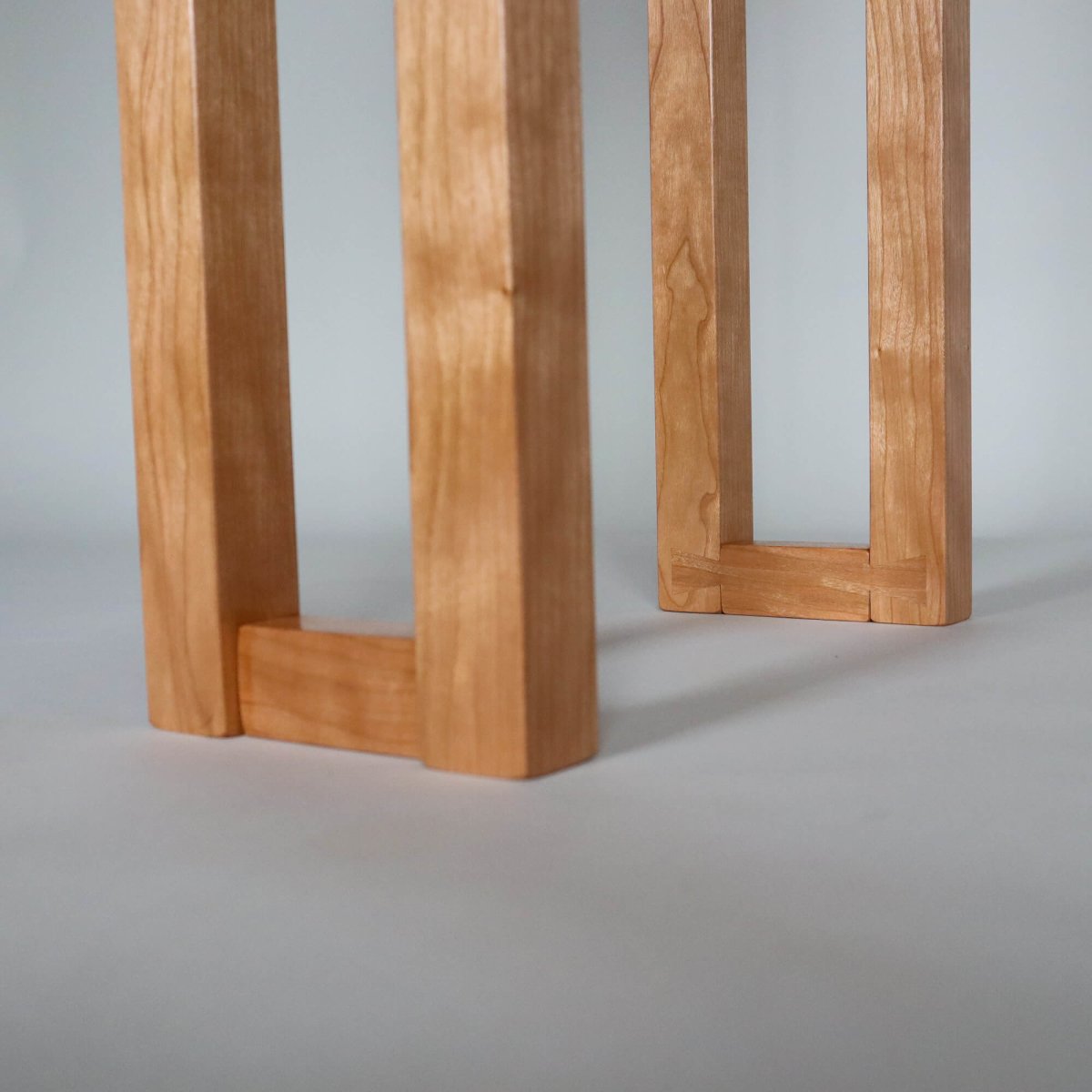 unique dovetail feet details on this modern wooden side table by Mokuzai Furniture- a narrow table with shelf for hallway decorating or small entryway design
