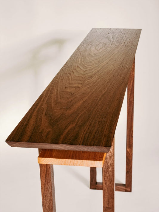 Premium solid woods of walnut and cherry create this narrow console table