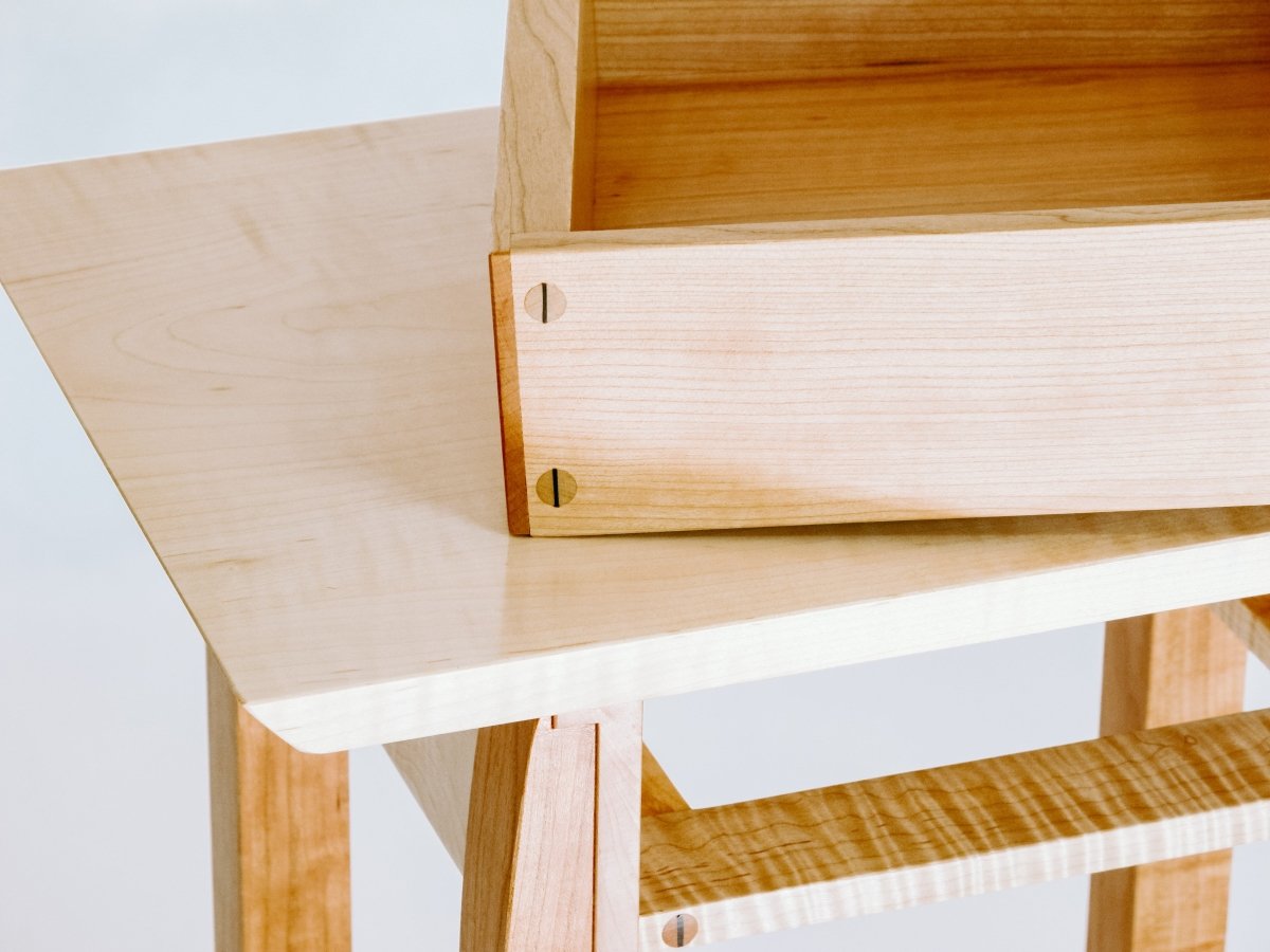 Drawer details on our small wood end table in tiger maple and cherry.  A modern wood furniture design by Mokuzai Furniture, thoughtfully sized for small space decorating, this little end table is the perfect accent table for your living room decor or small bedroom design