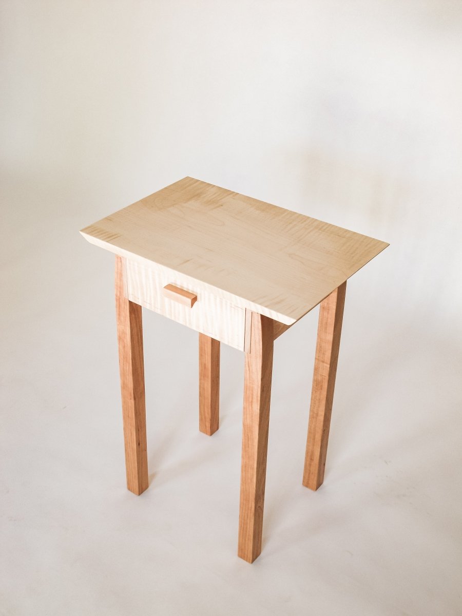 A small end table with drawer.  tiger maple and cherry table with storage.  A narrow end table for your living room furniture or a small nightstand for your bedroom decor.