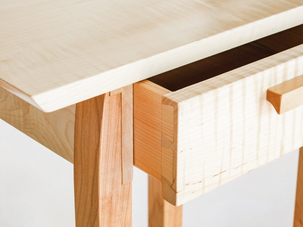 This small end table with drawer has hand-cut dovetail details at the sides of the drawer.  A small narrow table with storage for your living room table or bedside table.