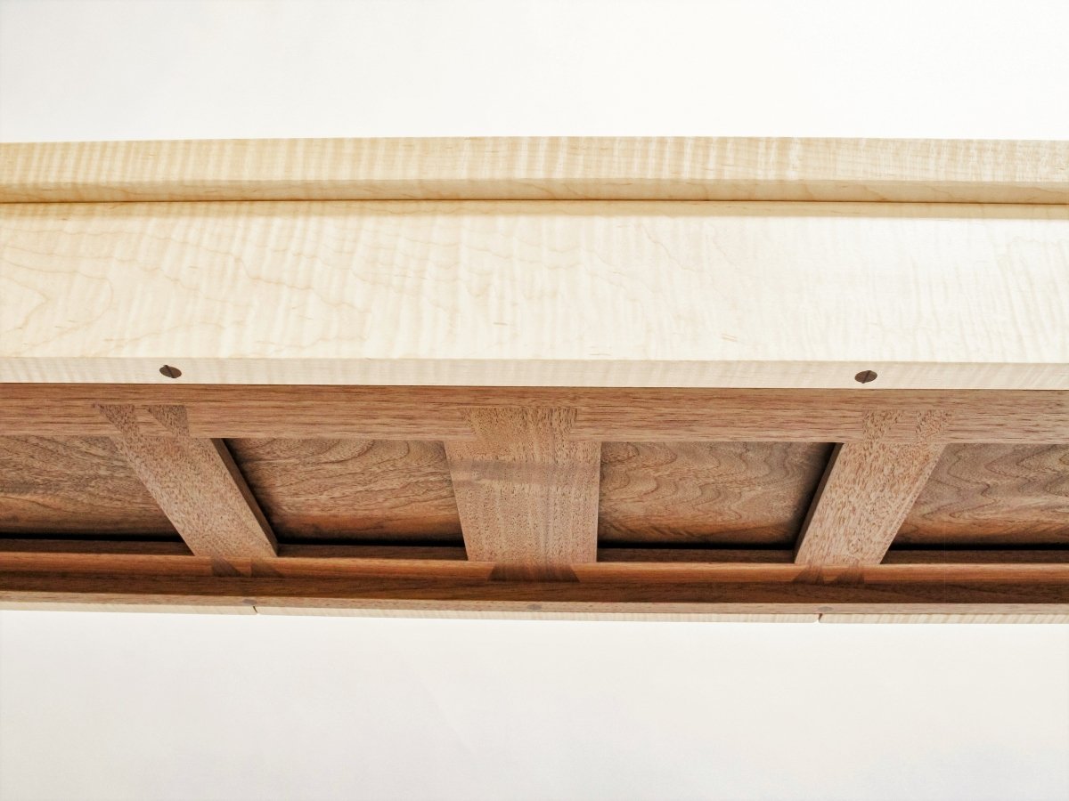 a uniquely designed web of interlocking dovetails support the narrow drawers at the top of our entry console table