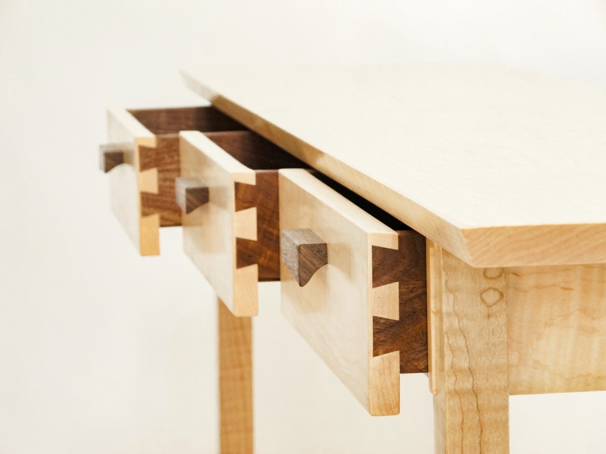 hand-cut dovetail joinery create these narrow wooded drawers on our entry console table