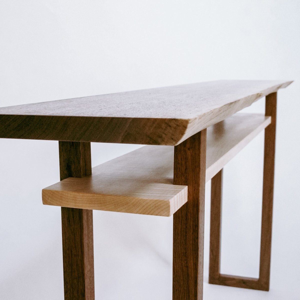 A live edge walnut modern wood console table by Mokuzai Furniture