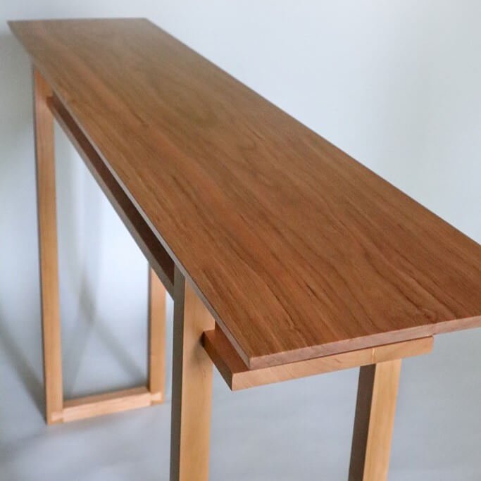 A modern cherry console table for hallways and entryways by Mokuzai Furniture.